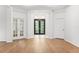 Bright foyer with wood floors, a decorative light fixture, and a view of the front doors at 17802 Mission Oak Dr, Lithia, FL 33547
