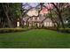 Charming single-story home with well-manicured lawn, lush landscaping, and mature trees at 17802 Mission Oak Dr, Lithia, FL 33547