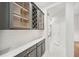 Butler's pantry with wine storage, granite countertops, and sleek cabinetry with tile backsplash at 17802 Mission Oak Dr, Lithia, FL 33547