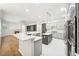 Modern kitchen with quartz countertops, stainless appliances, and seamless living room access at 17802 Mission Oak Dr, Lithia, FL 33547
