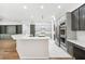 Bright kitchen features large island with white countertop, stainless appliances, and gray cabinets at 17802 Mission Oak Dr, Lithia, FL 33547