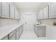 Well-organized laundry room with ample cabinet and counter space at 17802 Mission Oak Dr, Lithia, FL 33547