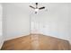 Bright living room boasts hardwood floors, crown molding, and a ceiling fan at 17802 Mission Oak Dr, Lithia, FL 33547