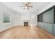 Bright living room with stone fireplace, built-in shelving and wood flooring at 17802 Mission Oak Dr, Lithia, FL 33547