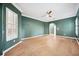 Living room with green walls, crown molding, shutters, wood floors, and ceiling fan at 17802 Mission Oak Dr, Lithia, FL 33547