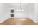 Open concept room with hardwood floors, modern lighting, and open access to bar at 17802 Mission Oak Dr, Lithia, FL 33547