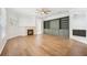 Open living room features hardwood floors, a fireplace, and custom built-in shelves at 17802 Mission Oak Dr, Lithia, FL 33547
