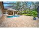This screened-in pool area boasts a beautiful pool, spa, and an outdoor cooking area for entertaining at 17802 Mission Oak Dr, Lithia, FL 33547