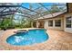 Backyard pool and spa with a screened-in lanai at 17802 Mission Oak Dr, Lithia, FL 33547