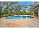 Relaxing screened-in pool with integrated spa and brick-paved deck, perfect for enjoying outdoor living at 17802 Mission Oak Dr, Lithia, FL 33547