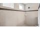 Shower features neutral tiling with decorative border and a rainfall shower head at 17802 Mission Oak Dr, Lithia, FL 33547