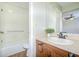 Bathroom vanity with classic fixtures, decorative plant, and shower with tile surround at 1799 N Highland Ave # 185, Clearwater, FL 33755