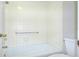 Clean white tiled shower and bath in a bright and airy bathroom at 1799 N Highland Ave # 185, Clearwater, FL 33755