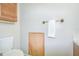 Powder room featuring a toilet, wooden cabinet and brass towel bar at 1799 N Highland Ave # 185, Clearwater, FL 33755