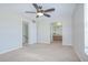 Carpeted main bedroom with ceiling fan, and access to the bathroom at 1799 N Highland Ave # 185, Clearwater, FL 33755