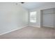 Carpeted bedroom featuring closet and window, providing natural light at 1799 N Highland Ave # 185, Clearwater, FL 33755