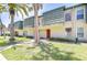 Inviting exterior showcasing palm trees, green lawn, and unique architectural details at 1799 N Highland Ave # 185, Clearwater, FL 33755
