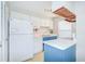 A white kitchen with blue trim, island, and white appliances at 1799 N Highland Ave # 185, Clearwater, FL 33755