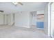 Bright living room with ceiling fans leading into the kitchen and out to the patio at 1799 N Highland Ave # 185, Clearwater, FL 33755