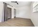 This bedroom boasts wood-look floors, a ceiling fan, and a closet with gray curtain at 2204 E Idlewild Ave, Tampa, FL 33610