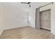 Bright bedroom featuring wood-look floors, a ceiling fan, and a closet with gray curtain at 2204 E Idlewild Ave, Tampa, FL 33610