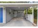 Covered carport area with a blue door and access to the main house at 2204 E Idlewild Ave, Tampa, FL 33610