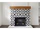 Striking decorative fireplace with black and white patterned tiles at 2204 E Idlewild Ave, Tampa, FL 33610