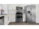 Well-equipped kitchen with stainless appliances and sleek white cabinetry at 2204 E Idlewild Ave, Tampa, FL 33610