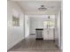 Open concept kitchen features stainless steel appliances, white cabinets, and modern light fixtures at 2204 E Idlewild Ave, Tampa, FL 33610