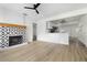 Open-concept living room with a decorative fireplace and stylish flooring at 2204 E Idlewild Ave, Tampa, FL 33610