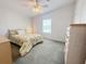 Bright bedroom with a floral accent bedspread, side tables, and a window providing natural light at 250 S Port Royal Ln, Apollo Beach, FL 33572