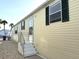 Side view of home's exterior, featuring well-maintained siding and attractive shuttered windows at 250 S Port Royal Ln, Apollo Beach, FL 33572