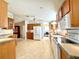 Functional kitchen featuring wood cabinets, white appliances, and a practical layout for cooking at 250 S Port Royal Ln, Apollo Beach, FL 33572