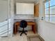 Compact home office space with a functional desk, overhead storage, and natural light at 250 S Port Royal Ln, Apollo Beach, FL 33572