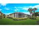 Screened lanai with nicely manicured landscaping in backyard at 2527 Terracina Dr, Venice, FL 34292