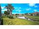 Scenic view of pond and palm trees, as seen from the backyard at 2527 Terracina Dr, Venice, FL 34292