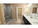 Bathroom with walk-in shower, double vanity, and access to walk-in closet at 2527 Terracina Dr, Venice, FL 34292