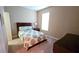 A simple bedroom with a comfortable bed and side table near a bright window at 2527 Terracina Dr, Venice, FL 34292