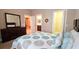 Spacious bedroom with large mirror and a view of the bathroom and closet at 2527 Terracina Dr, Venice, FL 34292