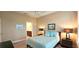 Comfortable bedroom featuring a wooden bed frame and soft blue accents at 2527 Terracina Dr, Venice, FL 34292
