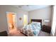 A bright bedroom with ceiling fan, complete with a bathroom and walk-in closet at 2527 Terracina Dr, Venice, FL 34292