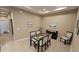A glass dining table set with six chairs in a well-lit dining room at 2527 Terracina Dr, Venice, FL 34292