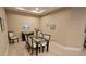 Dining room featuring a glass table, six chairs, and neutral decor at 2527 Terracina Dr, Venice, FL 34292