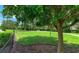 Fenced dog park featuring grassy areas, shade trees, and walking paths at 2527 Terracina Dr, Venice, FL 34292