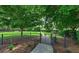 Community dog park area with lush green grass, mature trees, and pet-friendly amenities at 2527 Terracina Dr, Venice, FL 34292