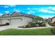 Charming villa featuring an attached garage, well-manicured landscaping, and a quaint front entrance at 2527 Terracina Dr, Venice, FL 34292