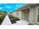 Cozy front entrance featuring a covered porch, well-maintained landscaping, and neutral tones at 2527 Terracina Dr, Venice, FL 34292