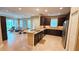 Open-concept kitchen featuring granite countertops, dark cabinetry, and seamless integration with living area at 2527 Terracina Dr, Venice, FL 34292