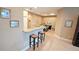 Open-concept kitchen featuring granite countertops, bar seating, and a bright, airy atmosphere at 2527 Terracina Dr, Venice, FL 34292