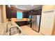 Well-equipped kitchen featuring stainless steel appliances, granite countertops, and dark wood cabinetry at 2527 Terracina Dr, Venice, FL 34292